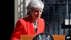 British Prime Minister Theresa May reacts as she turns away after making a speech in the street outside 10 Downing Street in London, England, May 24, 2019. 