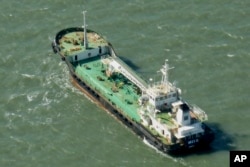 In this photo taken Monday, Oct. 27, 2014, the Aris 13 oil tanker is seen from a helicopter in the harbor of Gladstone, Australia. Pirates have hijacked the Aris 13 oil tanker off the coast of Somalia, officials and piracy experts said Tuesday, March 14, 2017, the first such seizure of a large commercial vessel on the crucial global trade route since 2012.