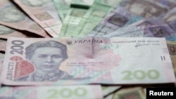 Ukrainian hryvnia banknotes are seen in a photo illustration shot in Kiev, August 6, 2014. Picture taken August 6, 2014. REUTERS/Konstantin Chernichkin (UKRAINE - Tags: BUSINESS) - RTR49DML