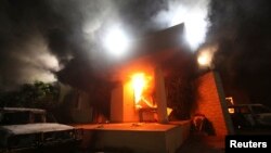 FILE - The U.S. Consulate in Benghazi is seen in flames during a protest by an armed group said to have been protesting a film being produced in the United States, Sept.11, 2012. 