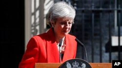 British Prime Minister Theresa May reacts as she turns away after making a speech in the street outside 10 Downing Street in London, England, May 24, 2019. 