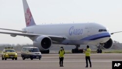 In this photo released by the Taiwan Centers for Disease Control, a China Airlines cargo plane carrying COVID-19 vaccines from Memphis arrive at the airport outside Taipei, Taiwan, Sunday, June 20, 2021. (Taiwan Centers for Disease Control via AP)