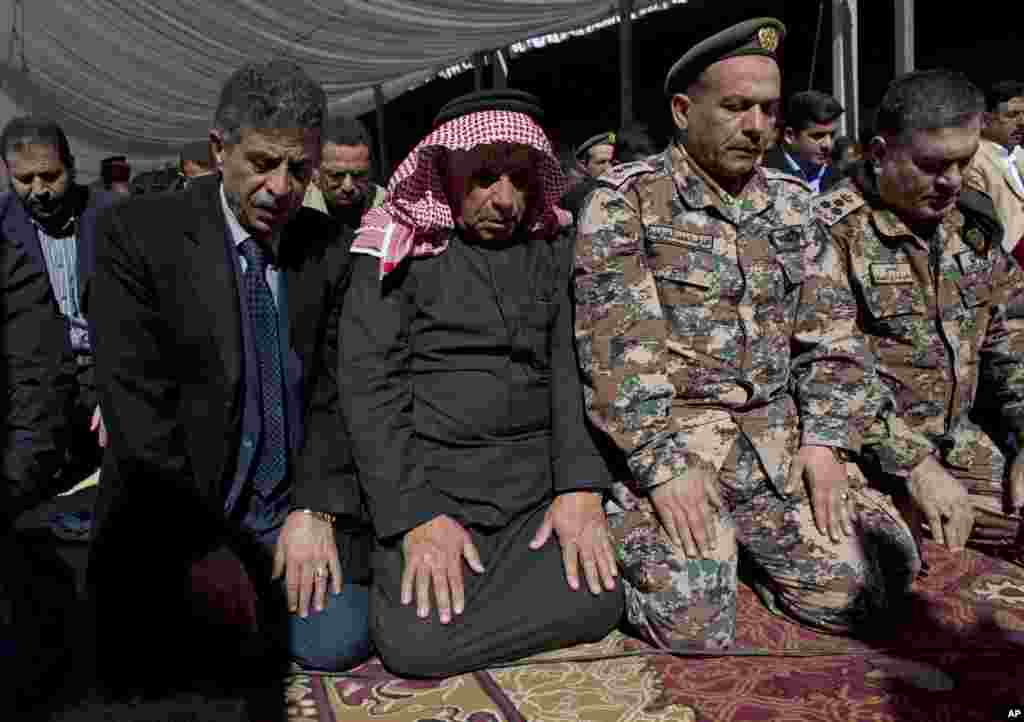 Safi al-Kaseasbeh, third right, father of slain Jordanian pilot, Lt. Muath al-Kaseasbeh attends a mass funeral at the Kaseasbeh tribe&#39;s gathering divan at their home village of Ai, near Karak, Jordan, Feb. 4, 2015.