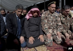 Safi al-Kaseasbeh, third right, father of slain Jordanian pilot, Lt. Muath al-Kaseasbeh attends a mass funeral at the Kaseasbeh tribe's gathering divan at their home village of Ai, near Karak, Jordan, Feb. 4, 2015.