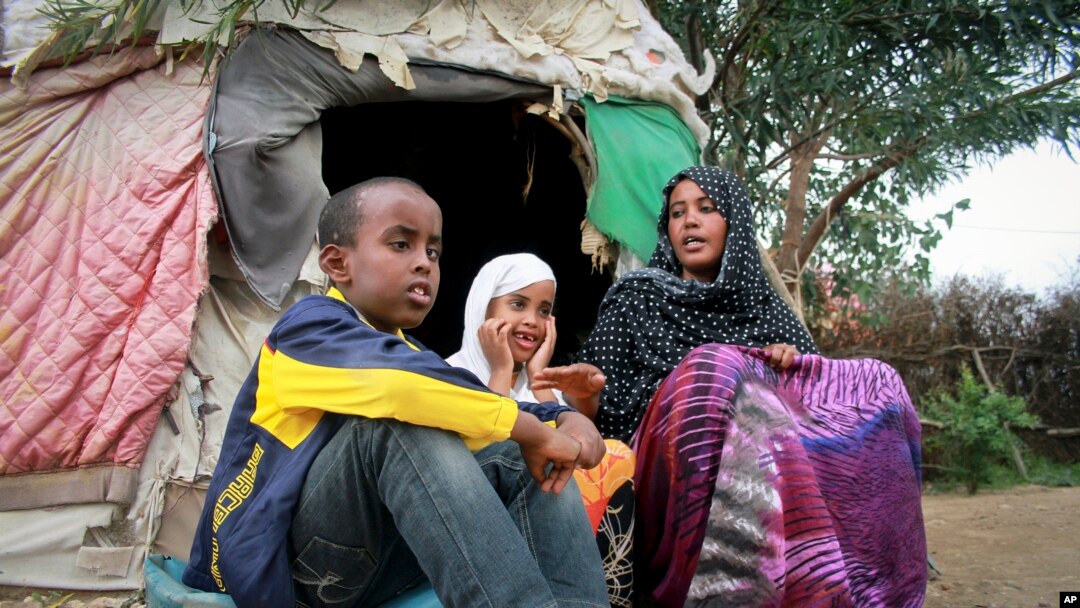 Ubah Mohamed Abdullahi, 33, right, sits with her son Abdullahi Yusuf Ahmed, 8, left, and daughter Neshad Yusuf Ahmed, 5, outside her hut in the Shedder refugee camp in far eastern Ethiopia. 