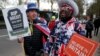 A pro-Brexit protester stands with anti-Brexit campaigner Steve Bray outside the Houses of Parliament in London, March 13, 2019. 