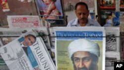 A roadside vendor sells newspapers with headlines about the death of al-Qaeda leader Osama bin Laden, in Lahore May 3, 2011. Pakistan's president acknowledged for the first time on Tuesday that his security forces were left out of a U.S. operation to kill