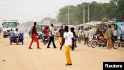 South Sudanese residents walk along a street of Bor, in Jonglei state. Around 1 million children in South Sudan have been forced to flee their homes since conflict erupted a year ago, Dec. 10, 2014.