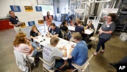 Supporters for Democratic presidential candidate Pete Buttigieg meet at a local brewery for a "relational phone bank", Aug. 29, 2019, in West Des Moines, Iowa.