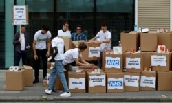 FILE - Protesters demonstrate against the stockpiling of medicines and food in the event of a no-deal Brexit in London, Britain. Aug 22, 2018.