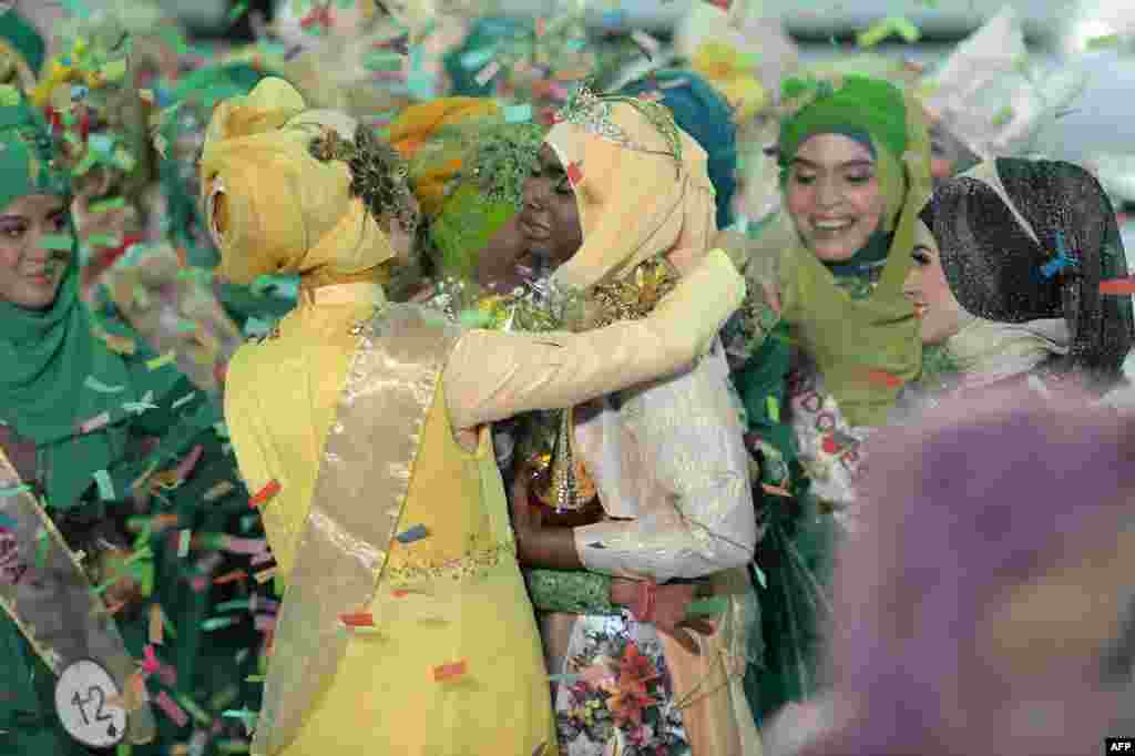 The newly crowned Miss Muslimah World 2013 Obabiyi Aishah Ajibola (C-R) of Nigeria is congratulated by contestants during the Muslimah World competition in Jakarta, Indonesia.