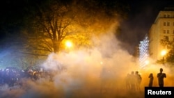 Tear gas is seen as demonstrators rally near the White House against the death in Minneapolis police custody of George Floyd in Washington, D.C. U.S. May 30, 2020. REUTERS/Eric Thayer
