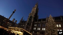 Visitors take a stroll at the Christmas market in front of the town hall at the Marienplatz square in Munich, Germany, Dec. 8, 2016. A strong police presence was felt at the square following the Berlin market attack.