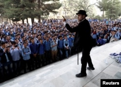 Afghanistan's Charlie Chaplin, Karim Asir, 25, performs at a school in Kabul, Afghanistan, Sept. 5, 2018.