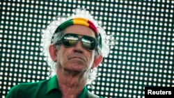 FILE - Keith Richards of the Rolling Stones performs during the group's "14 on Fire" show at Waldbuehne in Berlin, June 10, 2014. 