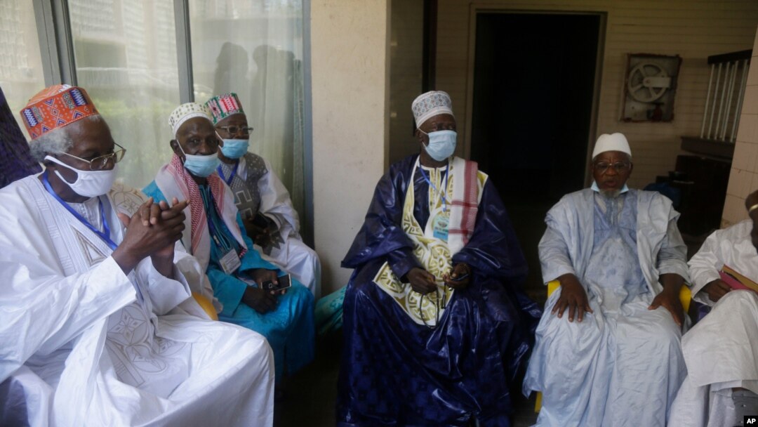 Religion leaders wait for a meeting with Military junta led by Col. Mamady Doumbouya, at the peoples palace in Conakry, Guinea Tuesday, Sept. 14, 2021. Guinea's junta is expected to face more pressure to set a timeframe for new elections Tuesday as…