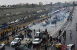 People protest against a gasoline price hike on a highway in Tehran, Iran, Nov. 16, 2019.