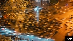 Thousands of college students ride bicycles on the Zhengkai Road in Zhengzhou, in northern China's Henan province, Nov. 9, 2024.