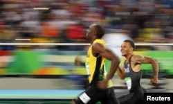 FILE - Jamaica's Usain Bolt and Canada's Andre De Grasse smile as they compete in the Men's 200m semi-finals at the Rio Olympics, Aug. 17, 2016.