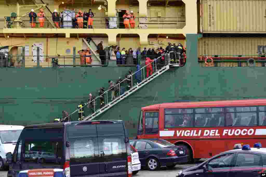 Passengers and crew of the Italian-flagged Norman Atlantic, that caught fire in the Adriatic Sea, disembark from a ship in Bari harbor, southern Italy, Dec. 29, 2014. 