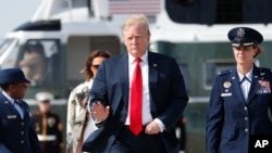 President Donald Trump and first lady Melania Trump walk from Marine One helicopter to board Air Force One, April 18, 2019, at Andrews Air Force Base, Md.