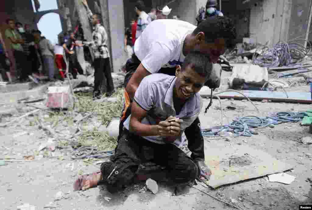 A Palestinian man reacts after the body of his mother was removed from the rubble of their house in Rafah, Gaza. Witnesses said the house was destroyed in an Israeli air strike.