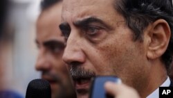 Fawaz al-Etan, the Jordanian ambassador in Libya, speaks to the press upon his arrival to Marka Military Airport, in Amman, Jordan, Tuesday, May 13, 2014