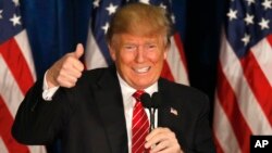 Republican presidential candidate Donald Trump gives a thumbs up at campaign stop in Portland, Maine, March 3, 2016.