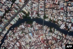 FILE - This aerial photo taken on October 19, 2018 shows houses along the Xuyen Tam canal in Ho Chi Minh City.