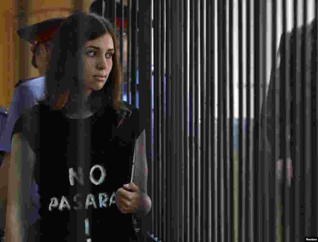 A member of the female punk band "Pussy Riot", Nadezhda Tolokonnikova, is escorted before a court hearing to appeal for parole at the Supreme Court of Mordovia in Saransk, Russia.