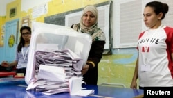 Election officials count ballots following Tunisia's parliamentary poll, in Tunis Oct. 26, 2014.