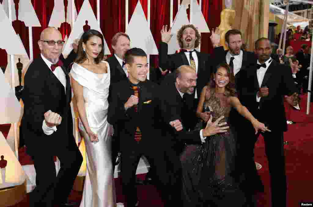 The cast and crew from best animated feature film nominee "BIG HERO 6" pose together at the 87th Academy Awards in Hollywood, California, Feb. 22, 2015. 