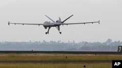 FILE - This Nov. 8, 2011 file photo shows a Predator B unmanned aircraft landing after a mission, at the Naval Air Station, in Corpus Christi, Texas. 