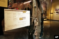 A piece of the rented van, and rental agreement, that began leading investigators to Muslim extremists who sought to punish the United States for its Middle East policies, according to prosecutors, in the Feb. 26, 1993 attack at the World Trade Center, are displayed at the National September 11 Museum, in New York, Feb. 23, 2018.