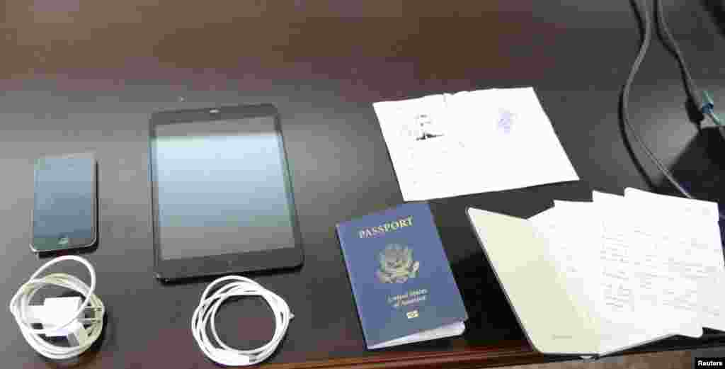 Personal possessions of U.S. citizen Matthew Todd Miller, including his passport and a ripped North Korean visa, are shown during his trial at the North Korean Supreme Court in this undated photo released by North Korea&#39;s Korean Central News Agency (KCNA), Pyongyang, Sept., 14, 2014. 