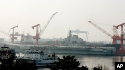 China's first aircraft carrier, the former Soviet carrier Varyag, which China bought from Ukraine in 1998, at the port of Dalian, in northeast China's Liaoning province, August 4, 2011.