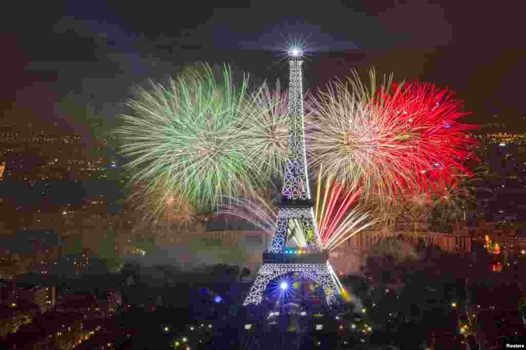 The Eiffel Tower is illuminated during the traditional Bastille Day fireworks display in Paris, July 14, 2013.