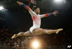 United States' Simone Biles performs on the balance beam during the gymnastics exhibition gala at the 2016 Summer Olympics in Rio de Janeiro, Brazil, Aug. 17, 2016.