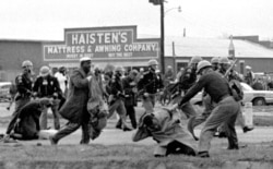FILE - Alabama state troopers use clubs against voting rights marchers in Selma on March 7, 1965. At foreground right, John Lewis, chairman of the Student Nonviolent Coordinating Committee, is beaten. (Associated Press)
