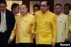 FILE PHOTO: Thailand's Prime Minister Prayuth Chan-ocha holds hands with Deputy Prime Minister and Defence Minister Prawit Wongsuwan at Government House in Bangkok, Thailand, April 11, 2019.
