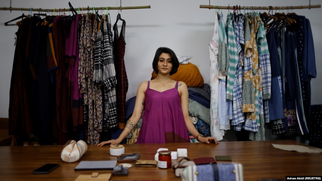 Kriti Tula is a fashion designer in New Delhi, India. Here she stands next to the clothes made from repurposed unused fabric at her factory on November 3, 2021. (REUTERS/Adnan Abidi)