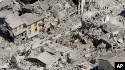 Rescuers search amid rubble following an earthquake in Amatrice Italy, Wednesday, Aug. 24, 2016. 