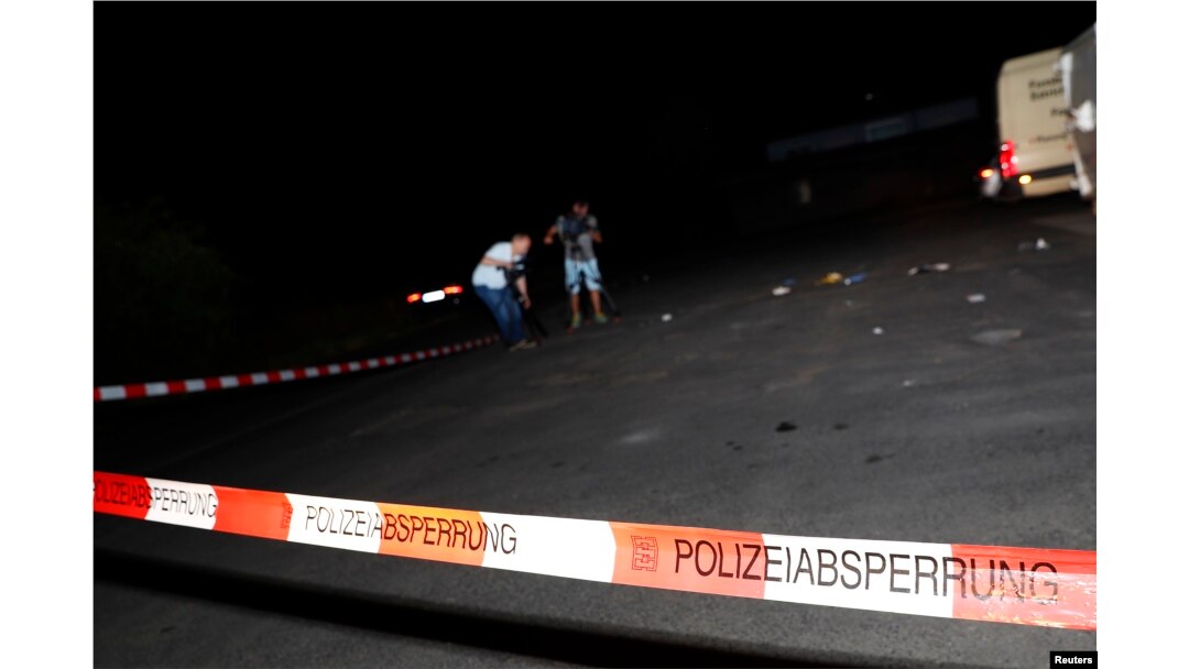 Cameramen film at the scene where a man was shot dead by the police after attacking passengers on a train with an axe near the city of Wuerzburg, Germany, July 19, 2016.