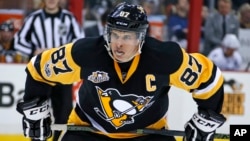 FILE - Pittsburgh Penguins' Sidney Crosby prepares for a face-off in the second period of an NHL hockey game against the Tampa Bay Lightning in Pittsburgh, March 3, 2017. Players are raising doubts about the finality of the NHL announcement that it won’t participate in the 2018 Olympics. Two-time Olympic gold-medal-winner Sidney Crosby said it was disappointing. 