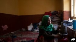 Khatira Habibi, 28, prepares tea in her home in Kabul, Afghanistan, Nov. 18, 2021. 