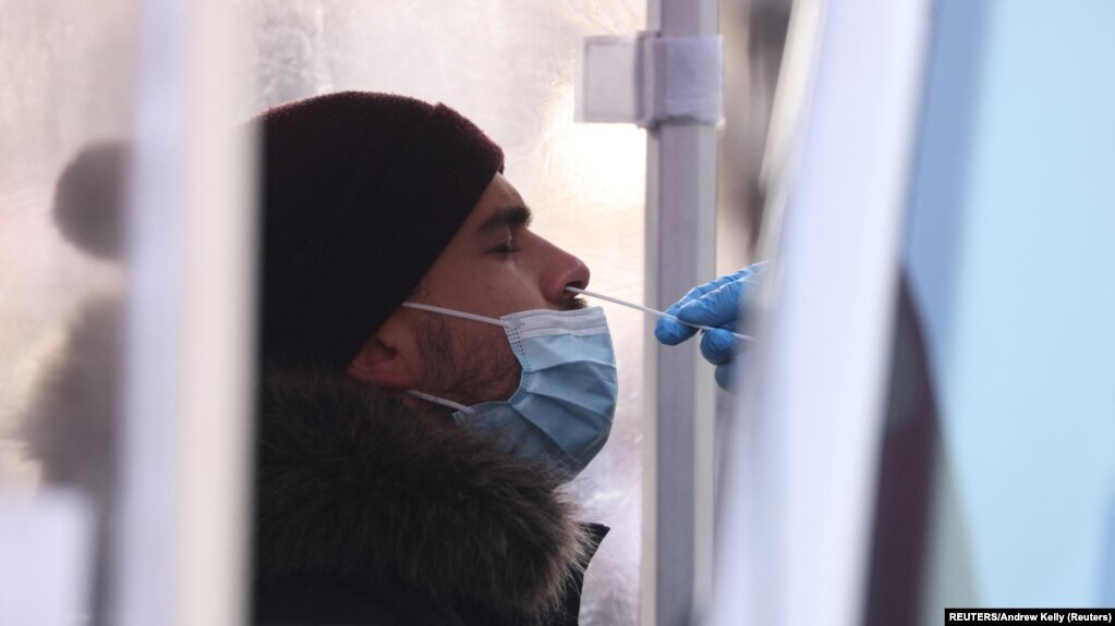 A person is tested for COVID-19 in Times Square as the Omicron coronavirus variant continues to spread in Manhattan, New York City, U.S., December 20, 2021. REUTERS/Andrew Kelly