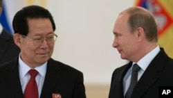 FILE - North Korea's ambassador to Russia, Kim Hyun Joon, pictured with Russian President Vladimir Putin in November 2014, says "it is well-known that the DPRK is already a nuclear state in both content and form."