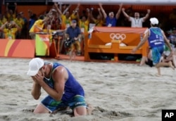 Brazil's Alison Cerutti, left, and Bruno Oscar Schmidt, right, celebrate winning a men's beach volleyball semifinal match against Netherlands at the 2016 Summer Olympics in Rio de Janeiro, Brazil, Aug. 16, 2016.