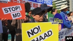 South Korean protesters hold placards during a rally against US Terminal High Altitude Area Defense (THAAD) system near the US embassy in Seoul on April 28, 2017.