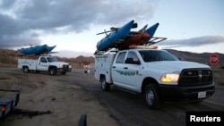 Search and rescue sheriff's vehicles arrive at the crash site of Virgin Galactic's SpaceShipTwo near Cantil, California Nov. 1, 2014.